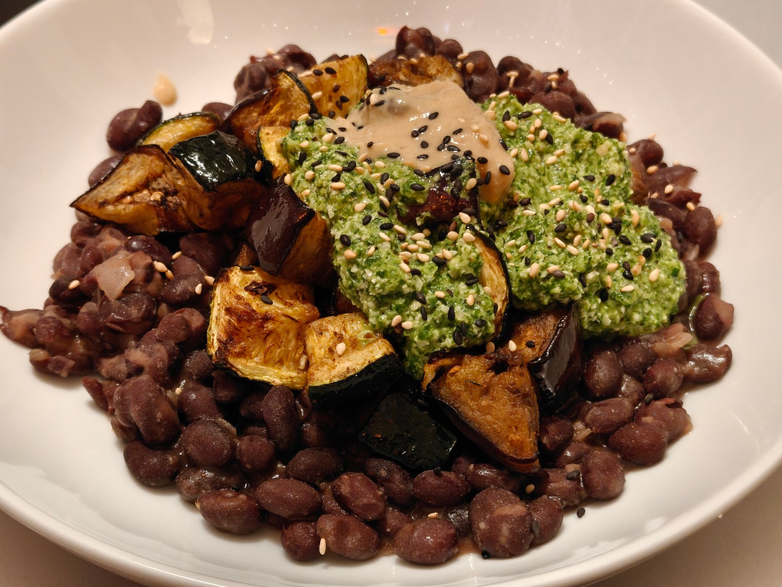 Charred Aubergine and Courgette with Coriander Cashew Chimichurri over Black Beans
